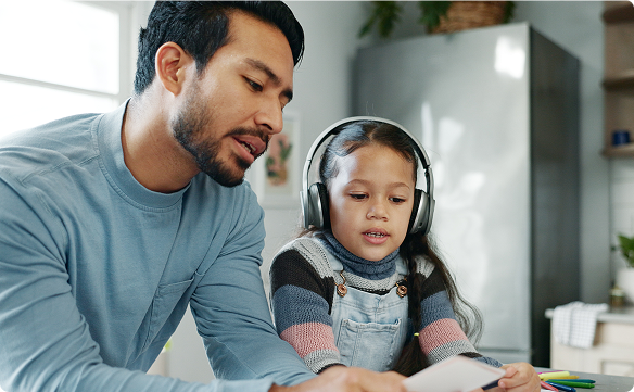 Dad and child with head phones talking with each other
